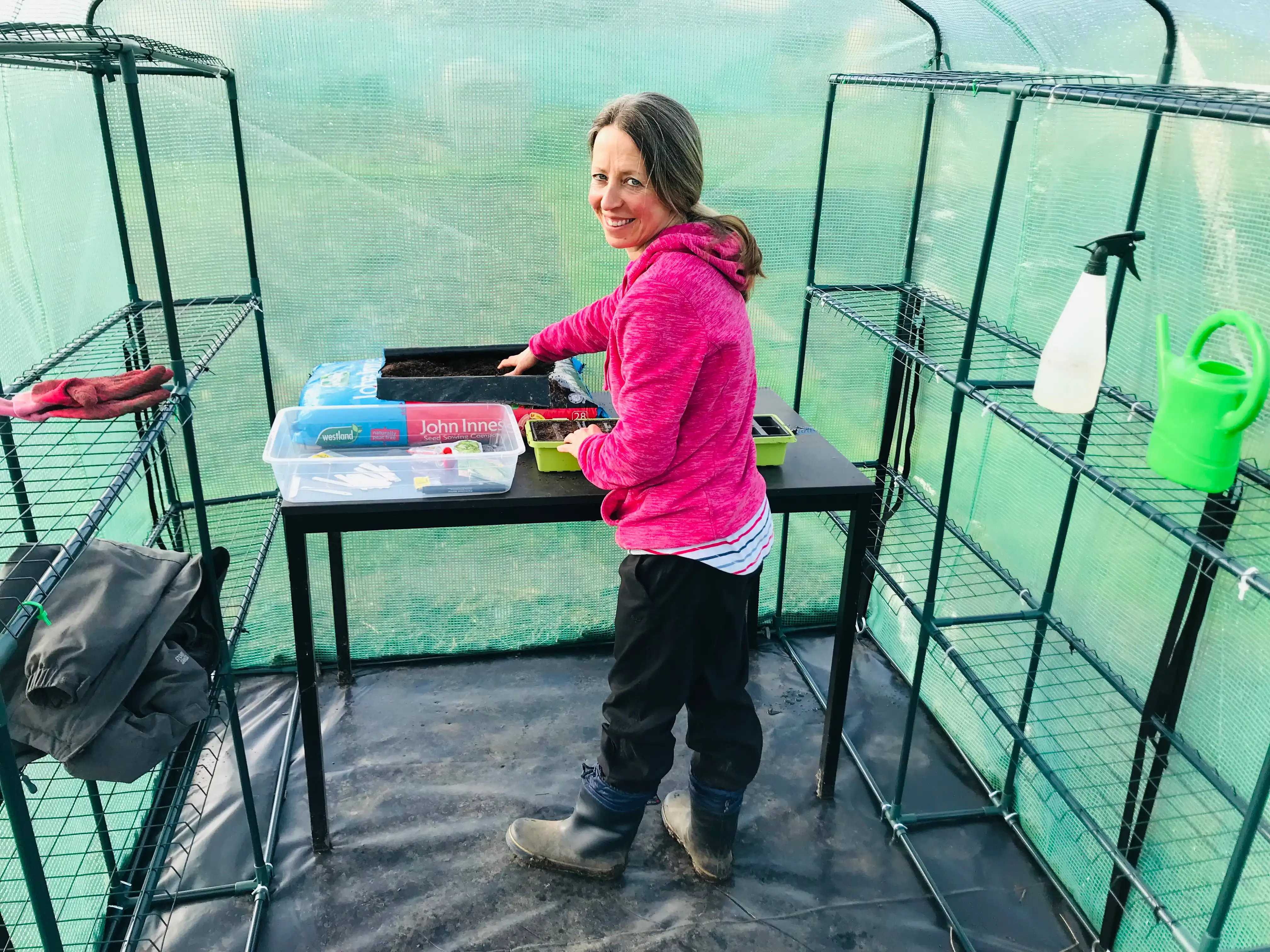 Vicky Salter sowing seeds in greenhouse