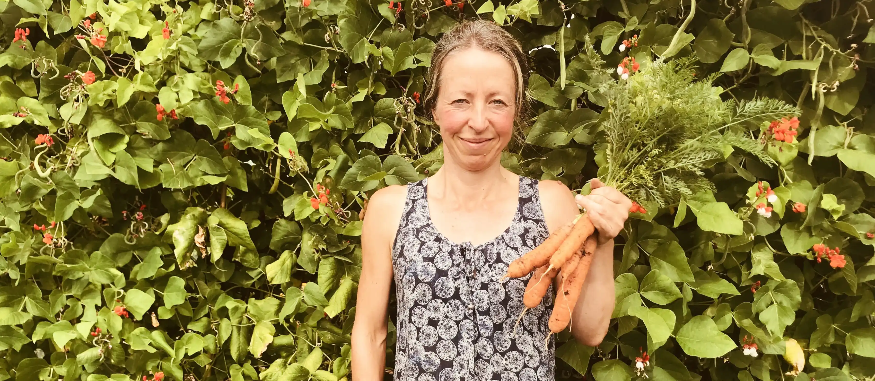 Vicky Salter holding carrots from the allotment.