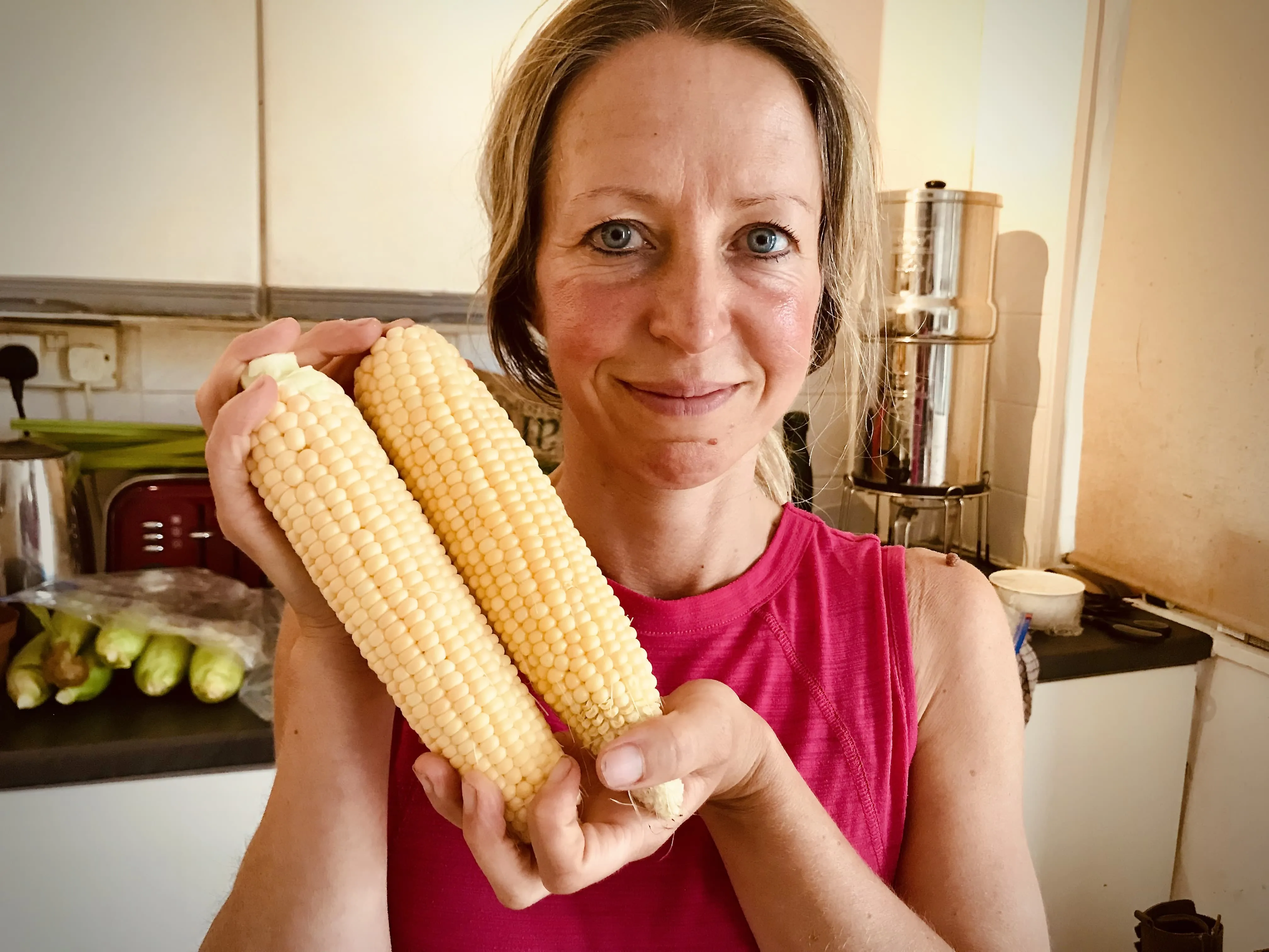 Vicky Salter holding two corn cobs.