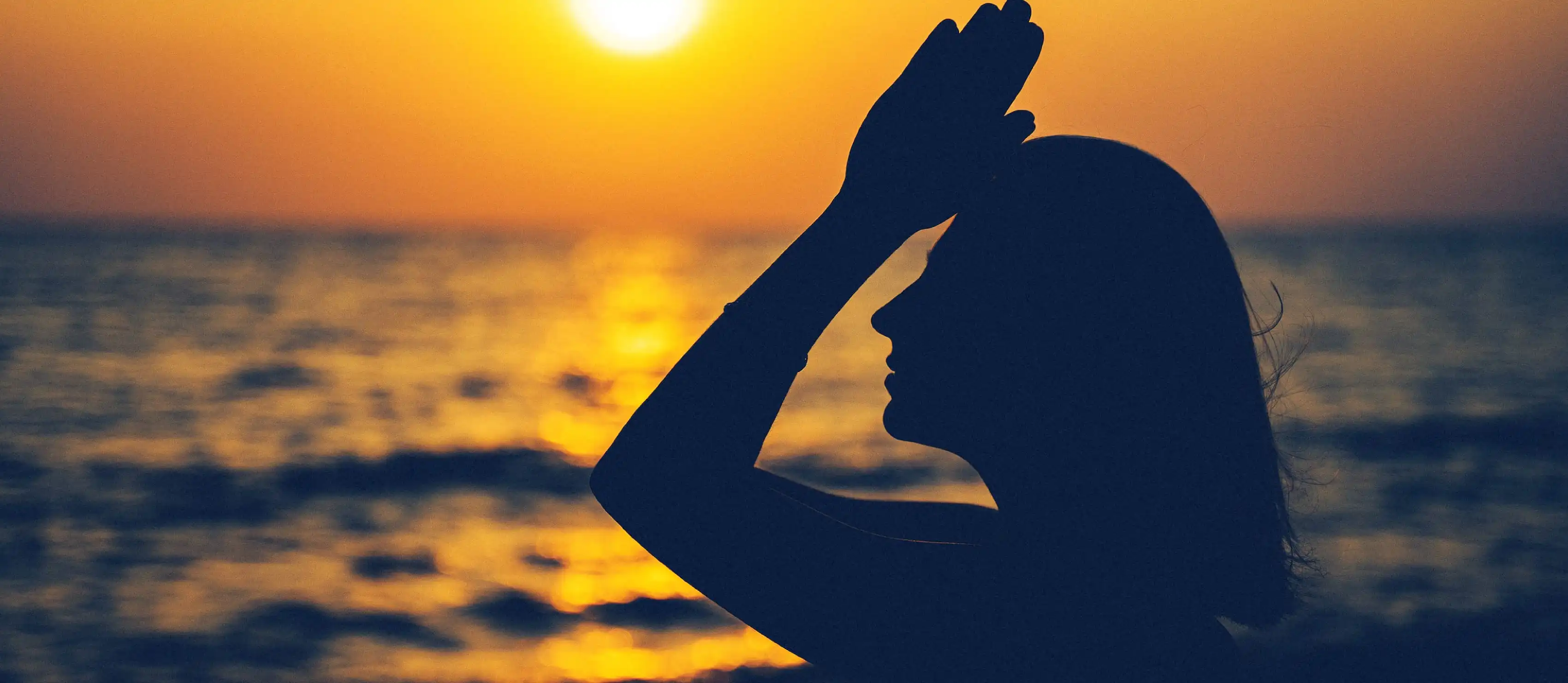 Yoga in front of sunset.