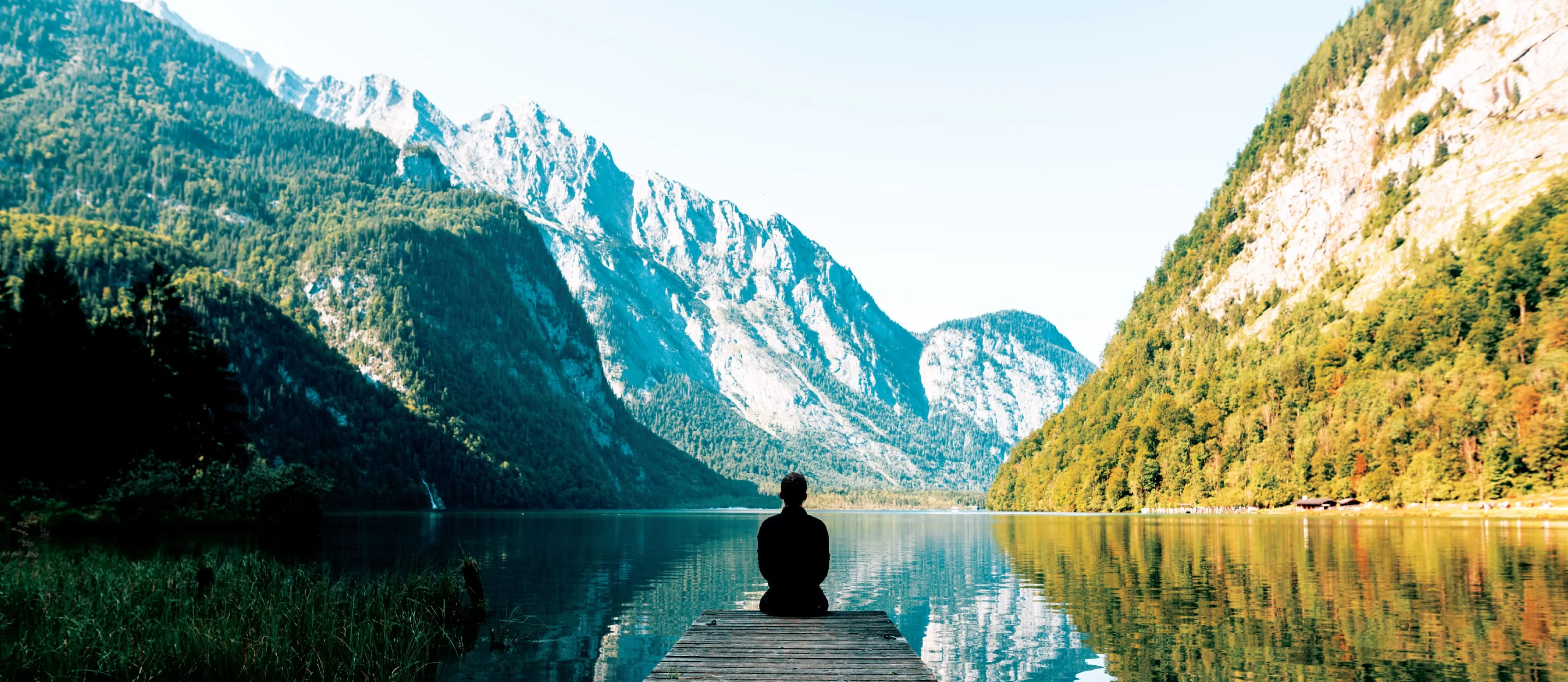 Man meditating on a jetty