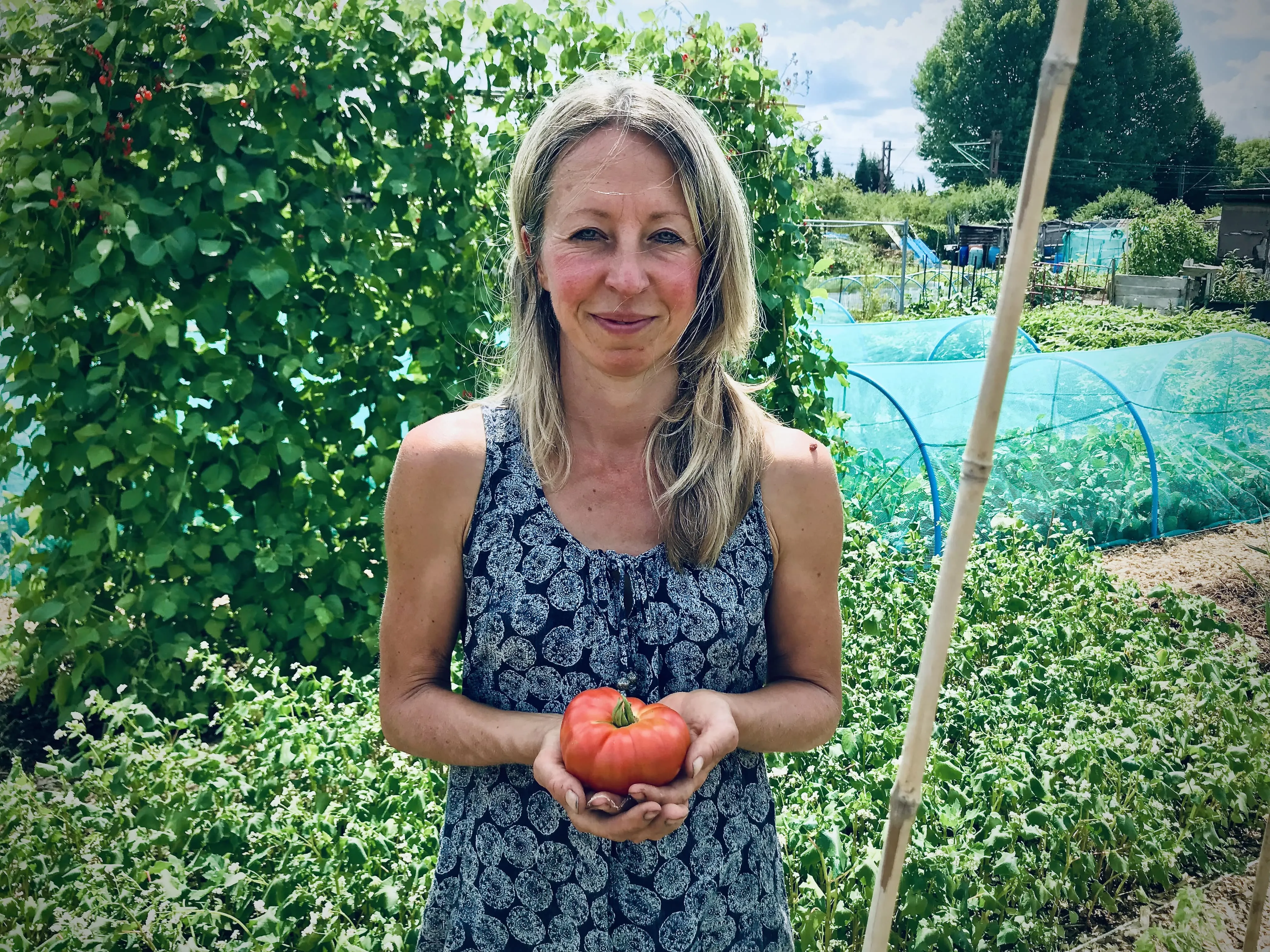 Vicky Salter holding a beefsteak tomato.