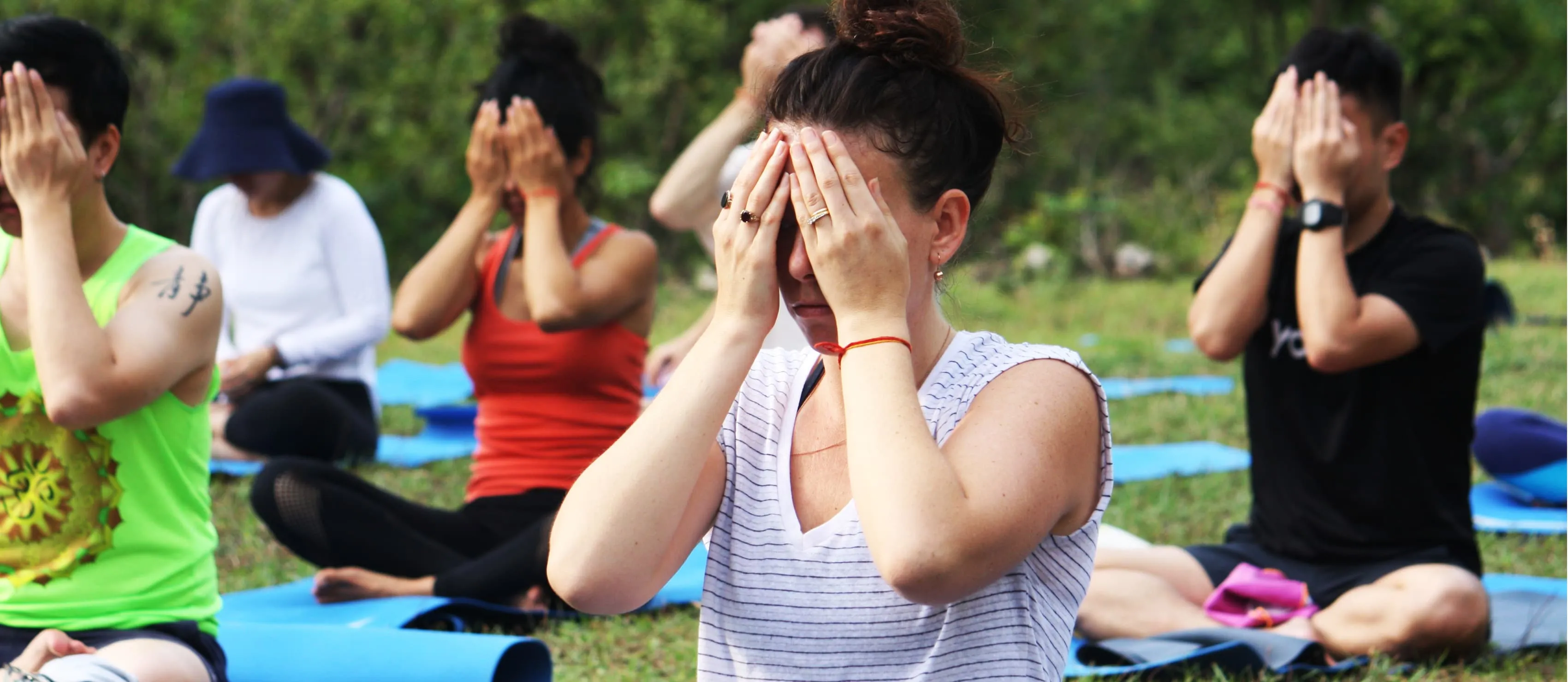 Outdoor yoga class meditating.