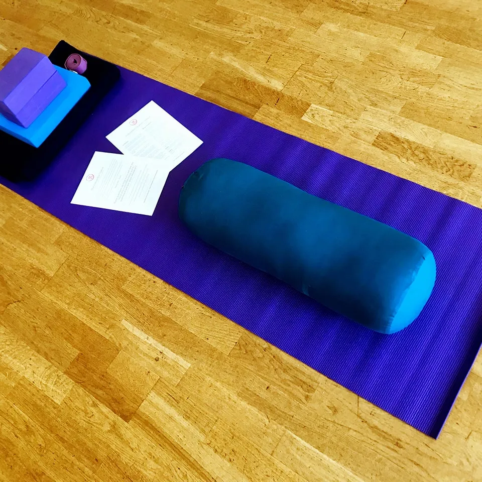 Bolster on a yoga mat.