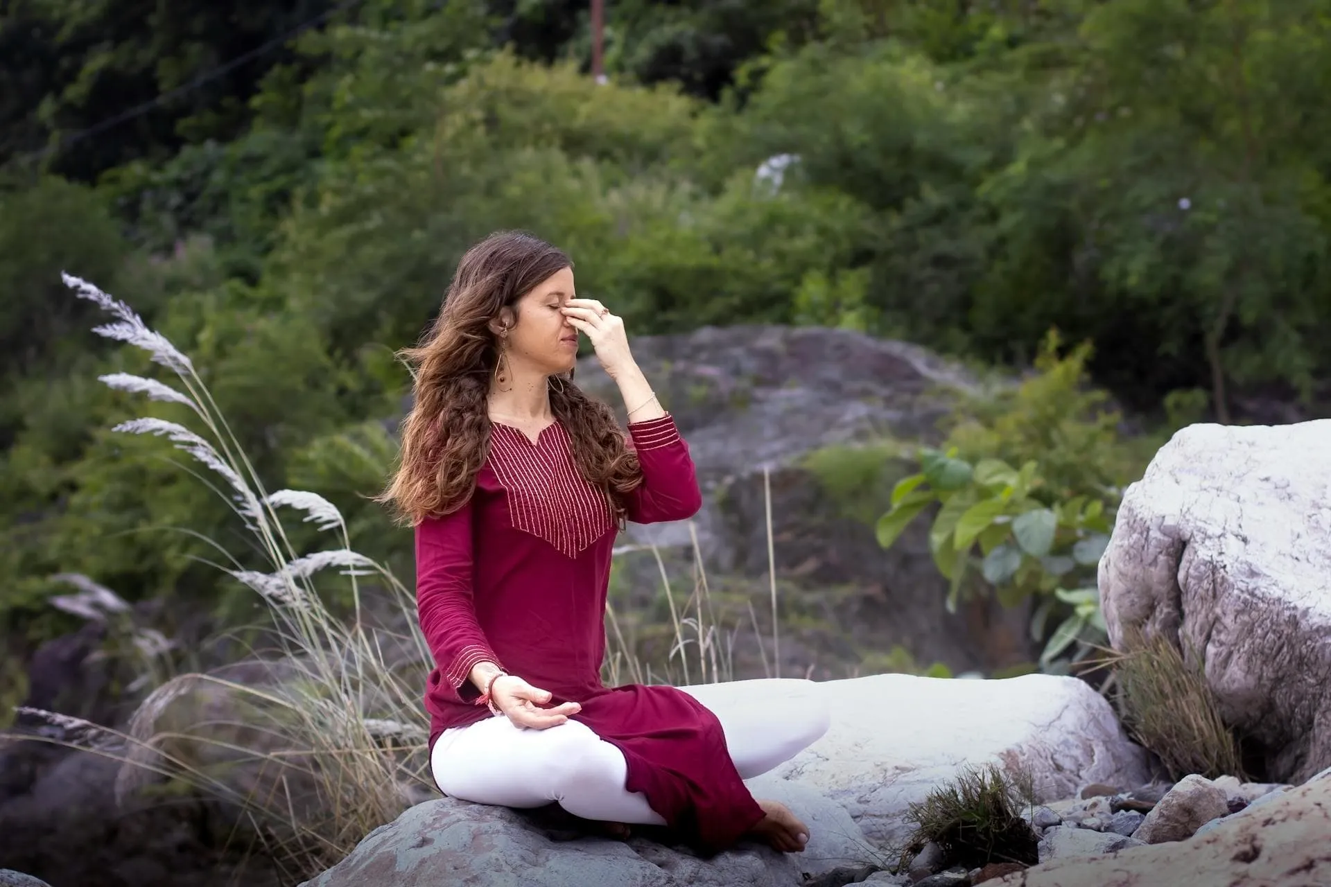 Woman practising alternate nostril breathing.