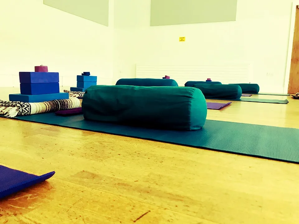 Bolster on a yoga mat.