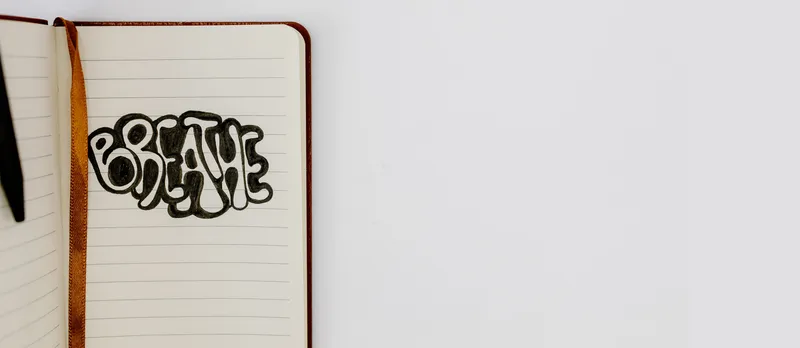 Breathe written on a notepad